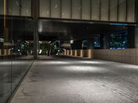 an open door at the lobby of a modern building with glass doors on either side