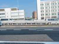 several cars parked along the highway in japan's capital city tokyo in the early morning