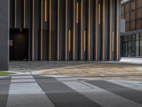 a walkway leading up to a wooden wall next to a cement area with floor tiles