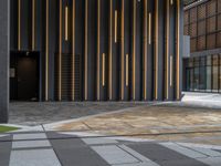 a walkway leading up to a wooden wall next to a cement area with floor tiles