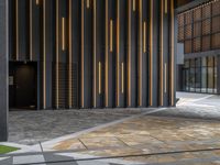 a walkway leading up to a wooden wall next to a cement area with floor tiles