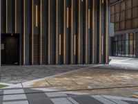 a walkway leading up to a wooden wall next to a cement area with floor tiles