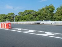 a red bus drives on the highway while other vehicles are driving behind it in traffic