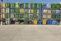 a group of bins on shelves in front of a warehouse with lots of empty containers