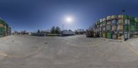 the spherical image is made to look like two buildings in a parking lot, with a parking meter at one side and other side