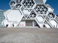 an artistic building with hexagons and windows on it's side,