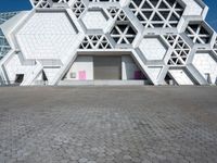 an artistic building with hexagons and windows on it's side,