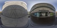 a curved mirror on the side of the building, reflecting the courtyard below it, which has a circular roof