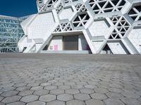 this is the entrance to a museum of art and design with geometric white architecture, designed by david young