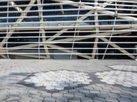 a person in front of a very large building with metal lines on it's side