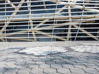 a person in front of a very large building with metal lines on it's side