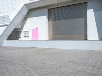 this is an image of a building with shutters and a pink door on it