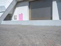 this is an image of a building with shutters and a pink door on it