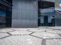 a stone pattern is placed in the center of a building's courtyard, leading to several different large windows