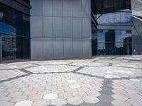 a stone pattern is placed in the center of a building's courtyard, leading to several different large windows