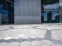 a stone pattern is placed in the center of a building's courtyard, leading to several different large windows