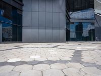 a stone pattern is placed in the center of a building's courtyard, leading to several different large windows