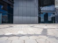 a stone pattern is placed in the center of a building's courtyard, leading to several different large windows