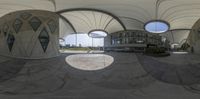 a sphere with several curved ceiling in it and an empty area next to the building