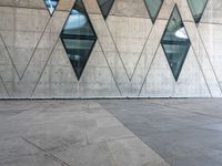 the white tiled floor is filled with some geometric shapes and windows on it's side