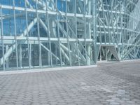 a young man rides his skateboard outside of a building made out of glass walls