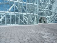 a young man rides his skateboard outside of a building made out of glass walls