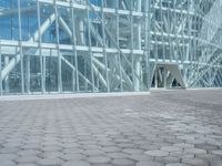 a young man rides his skateboard outside of a building made out of glass walls