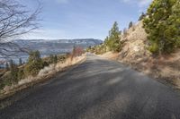 the road near a mountain is empty and has no traffic or people on it,