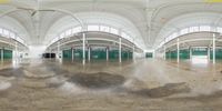 an empty room with a lot of windows and a skate board on the ground in it