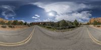 a double street is shown on the other side of this image with a cloudy sky overhead