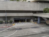 an airport has several signs in its parking garage while people walk by the walkway and stairs on the right