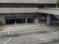 an airport has several signs in its parking garage while people walk by the walkway and stairs on the right