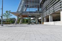 there is a sidewalk in front of a building with columns and windows to let some light into the courtyard