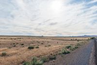 Landscape of Utah's San Rafael Swell with Red Rocks and Open Grass Field