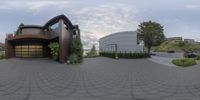 a 360 lens photo of a large modern house with driveway in front of it and landscaping