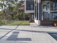 this large patio has a deck overlooking a city and trees from the outside side of it