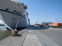 large ship docked in the harbor next to rail tracks and water walkways on the shore