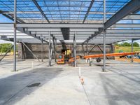 the interior of a large structure under construction with large beams, walls and a metal roof