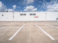 the front of a large warehouse with no parking spots on it's concrete surface