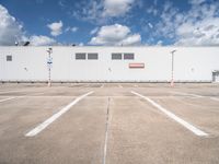 the front of a large warehouse with no parking spots on it's concrete surface