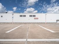 the front of a large warehouse with no parking spots on it's concrete surface