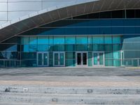 the front entrance to an airport is almost empty, which is quite clear from all of the elements