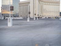 a city street with no pedestrians or cars in the parking lot in front of a casino