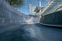 a curved metal rail and a walkway in between the concrete walls of an indoor arena