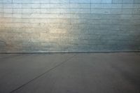 the man is on his skateboard near the building outside the wall of the building