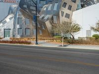 a building with a strange design on the side of it next to a street corner