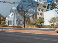 a building with a strange design on the side of it next to a street corner