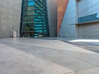 the city has a very long stone paved street outside the center, with blue windows and reflections on the side of it