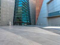 the city has a very long stone paved street outside the center, with blue windows and reflections on the side of it