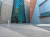 the city has a very long stone paved street outside the center, with blue windows and reflections on the side of it